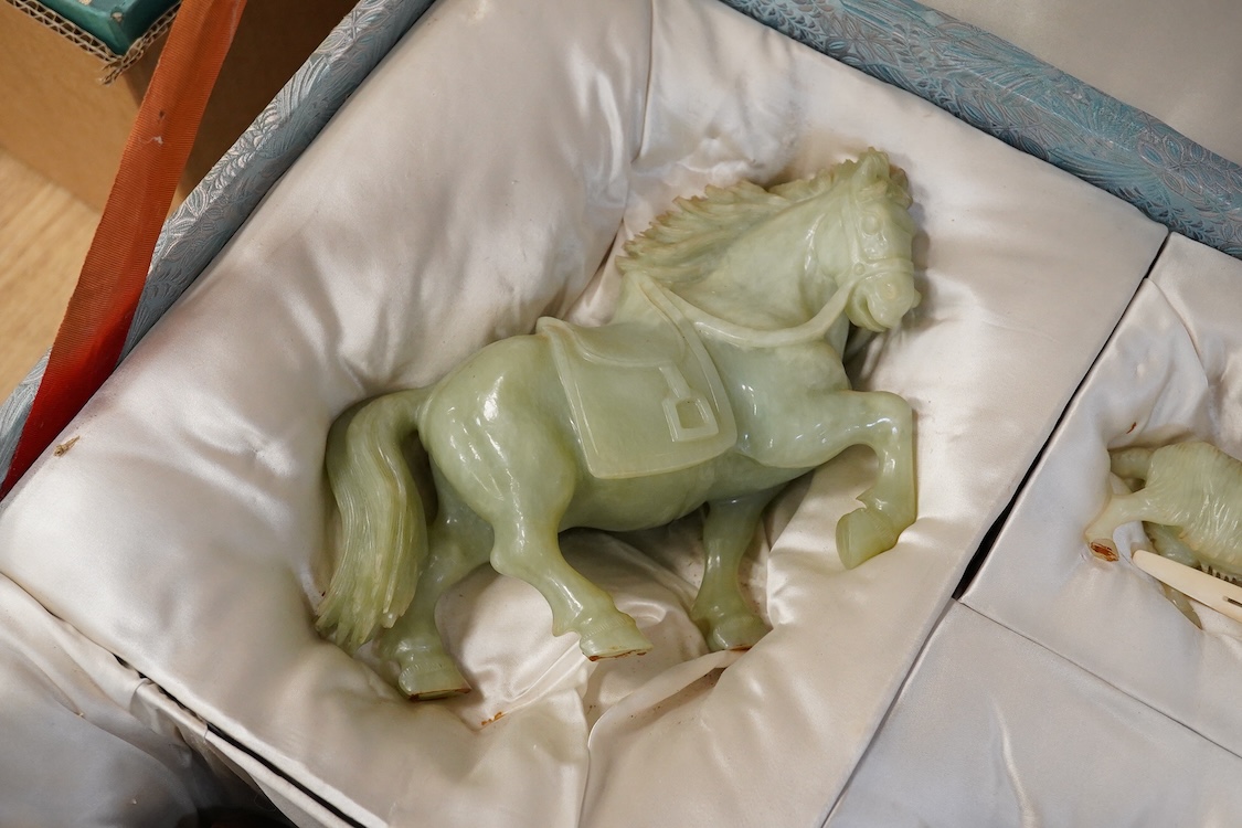 A Chinese silk brocade box containing six Chinese hard stone coloured carved animals and a wooden and metal inlaid stand, largest a horse 19cm wide